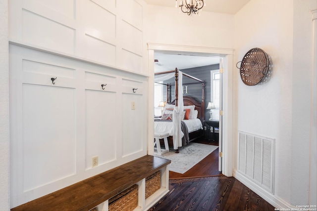 mudroom featuring visible vents and dark wood-style flooring