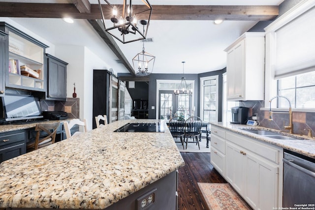 kitchen featuring a sink, a chandelier, beamed ceiling, black electric cooktop, and stainless steel dishwasher