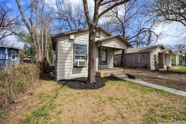 bungalow featuring a porch and cooling unit