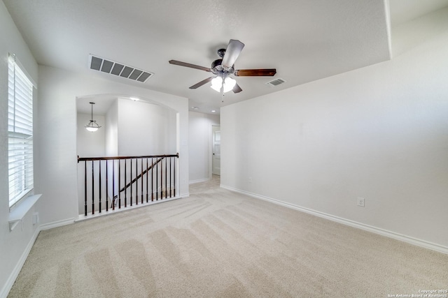 spare room featuring visible vents, baseboards, carpet, and ceiling fan