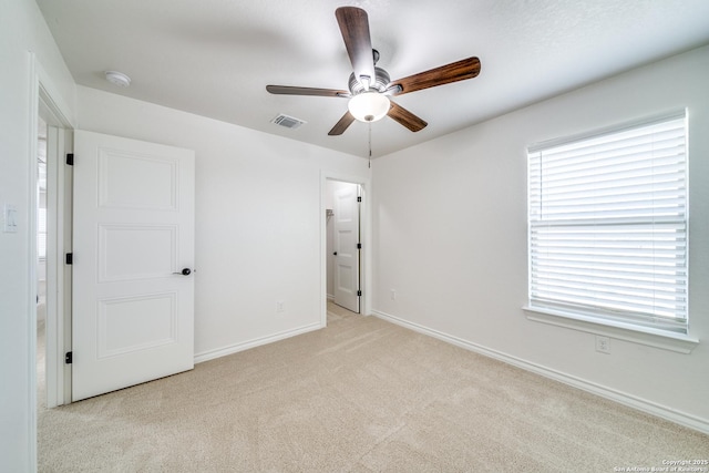 unfurnished bedroom featuring visible vents, a ceiling fan, connected bathroom, carpet, and baseboards