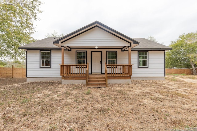 view of front facade featuring a porch and fence