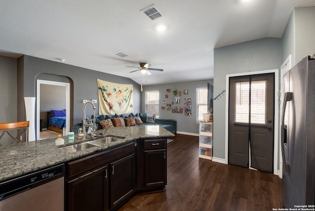 kitchen with visible vents, dark wood-type flooring, open floor plan, stainless steel appliances, and a sink