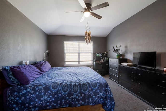 bedroom with ceiling fan, lofted ceiling, and carpet floors