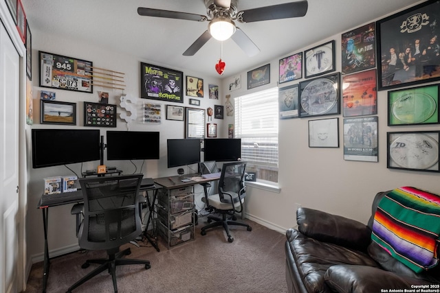 carpeted home office with baseboards and ceiling fan