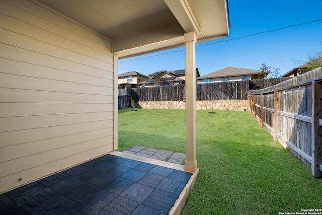 view of yard featuring a patio and a fenced backyard