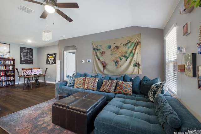 living room with visible vents, dark wood-type flooring, arched walkways, ceiling fan, and vaulted ceiling