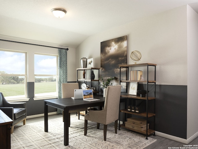 office area featuring baseboards, lofted ceiling, and wood finished floors