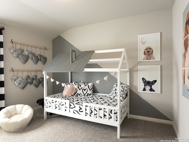 carpeted bedroom with baseboards and vaulted ceiling