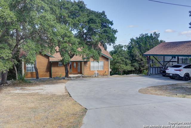 view of front of house featuring a carport and concrete driveway