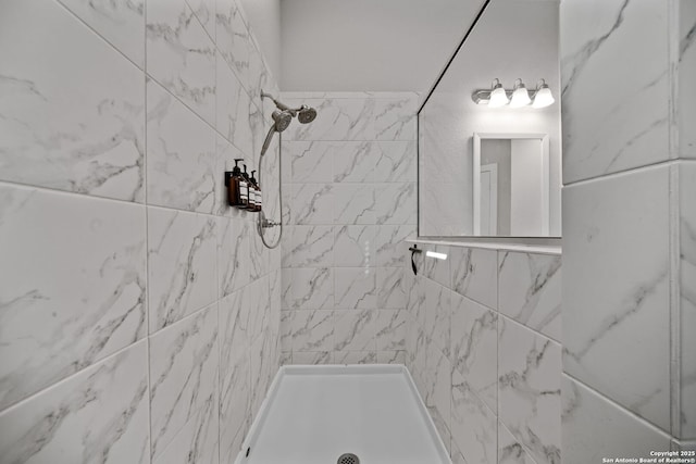 full bath featuring a tile shower