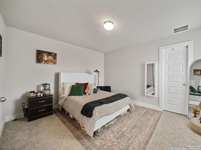 bedroom featuring visible vents, baseboards, and carpet floors