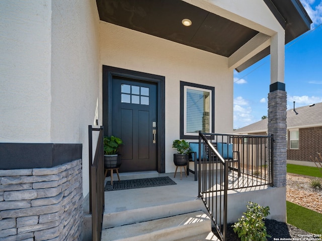 doorway to property featuring stucco siding