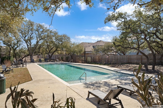 view of pool with a fenced in pool, fence, and a patio area