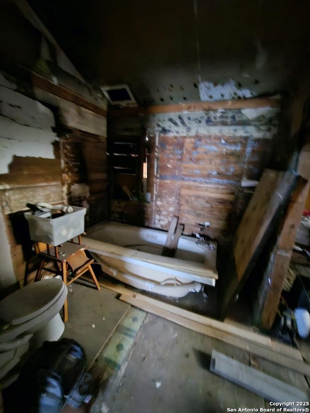 full bathroom with a bathing tub and toilet