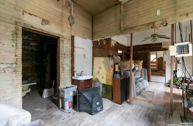 miscellaneous room featuring a sink, wood finished floors, and a ceiling fan