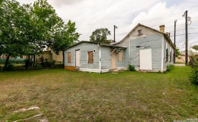 back of property featuring a yard