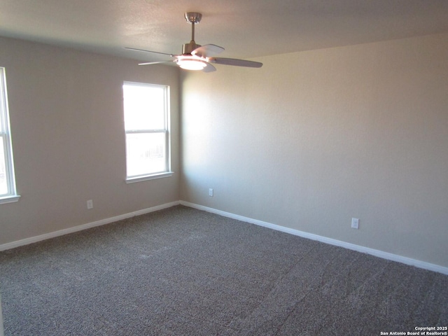 carpeted empty room with baseboards and ceiling fan