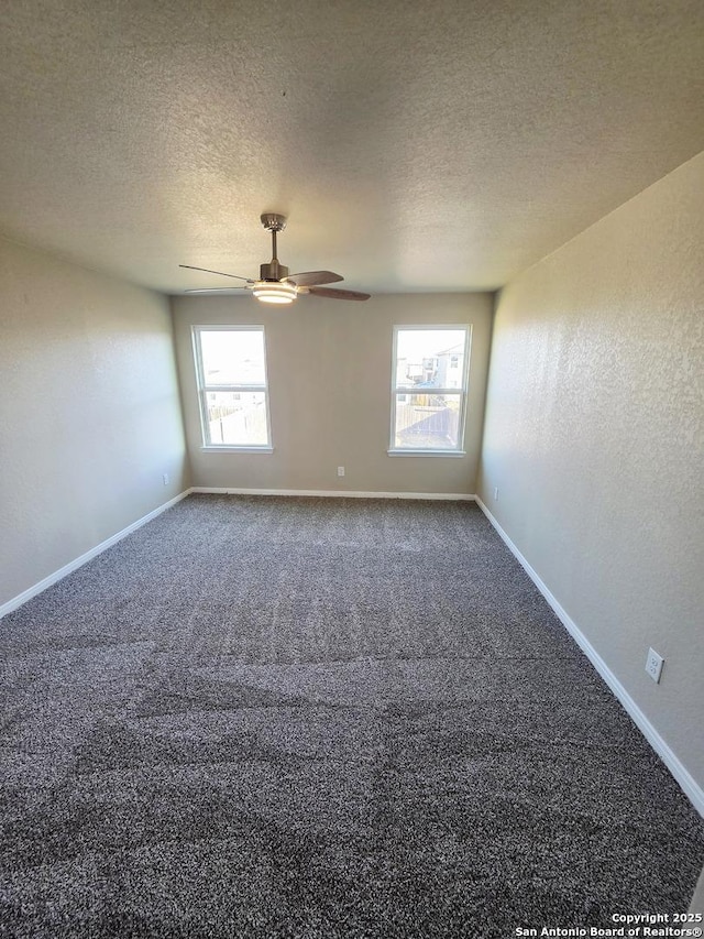 spare room featuring a ceiling fan, a textured ceiling, carpet, baseboards, and a textured wall