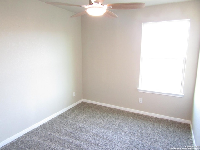 carpeted spare room with baseboards and ceiling fan