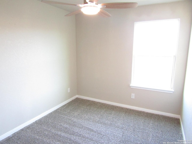 spare room with baseboards, carpet, and ceiling fan