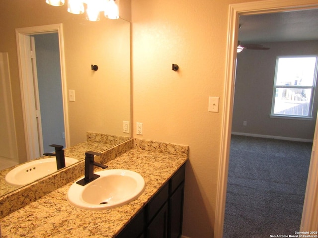 bathroom with vanity and baseboards