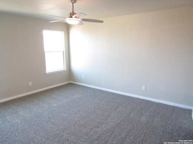 carpeted empty room featuring a ceiling fan and baseboards