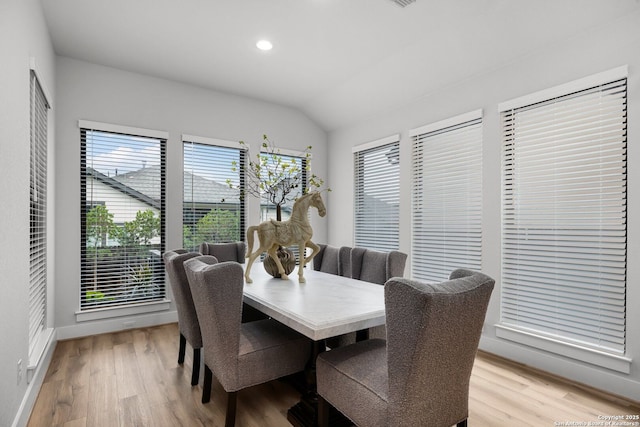 dining area featuring recessed lighting, light wood-type flooring, baseboards, and vaulted ceiling