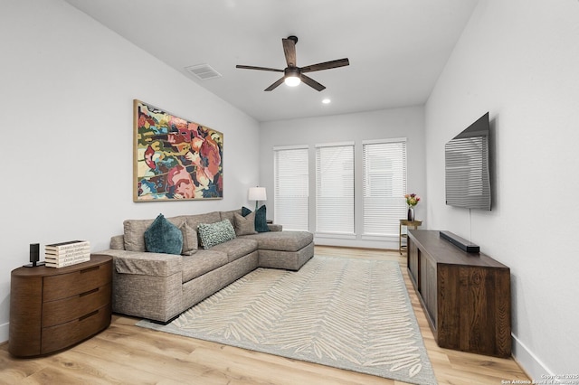 living room with a ceiling fan, visible vents, baseboards, light wood-style flooring, and recessed lighting