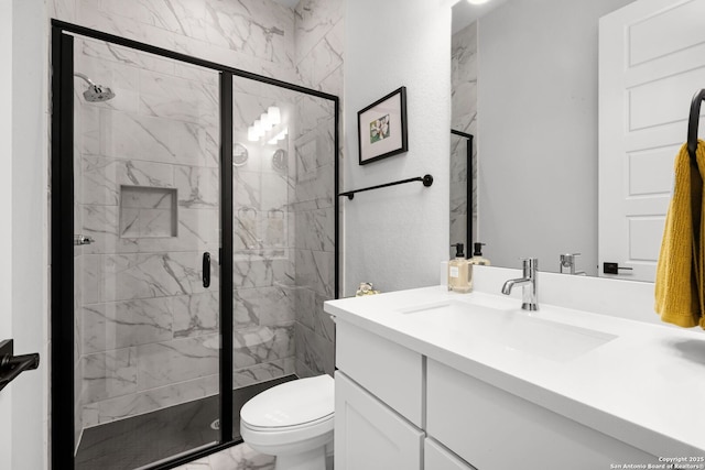 bathroom with vanity, toilet, marble finish floor, and a marble finish shower