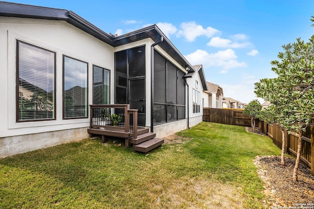 view of yard with a fenced backyard and a sunroom