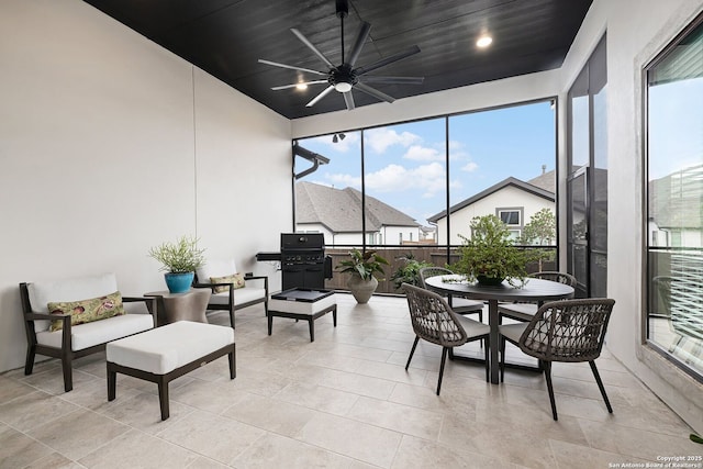 sunroom featuring ceiling fan