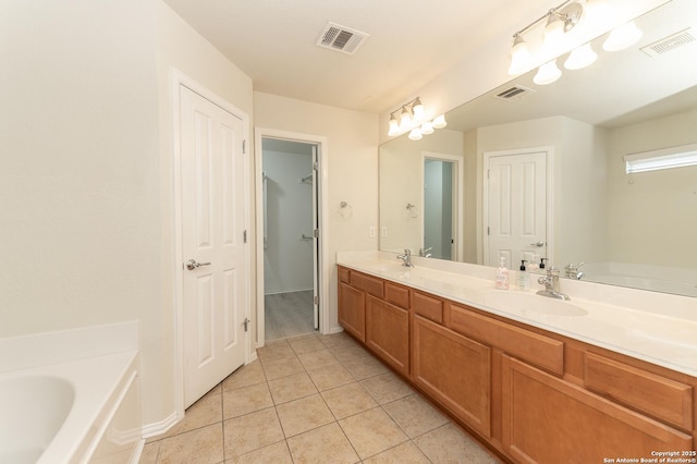 bathroom with a sink, visible vents, and tile patterned flooring