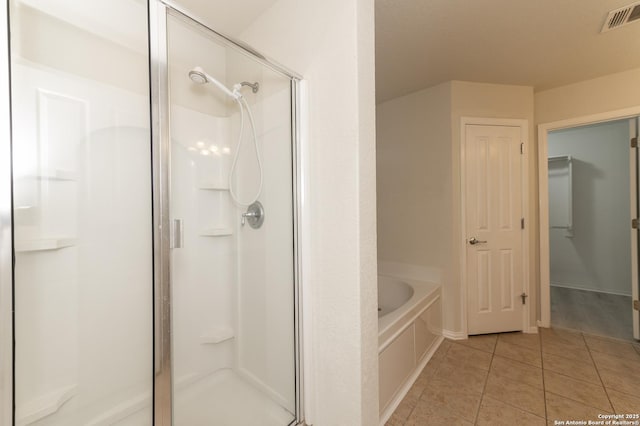 bathroom featuring tile patterned flooring, a garden tub, visible vents, and a stall shower