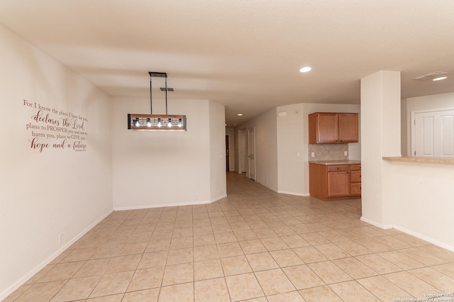 spare room featuring light tile patterned flooring, recessed lighting, and baseboards