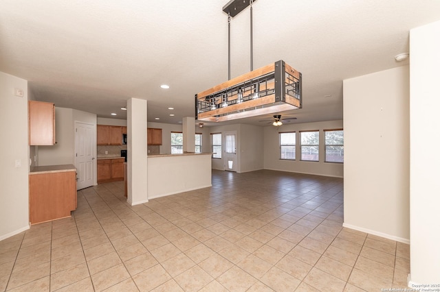 unfurnished living room featuring light tile patterned floors, baseboards, recessed lighting, and a ceiling fan