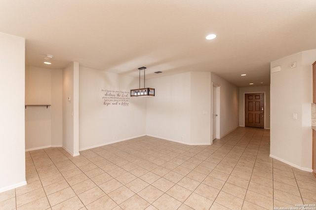 spare room with recessed lighting, baseboards, and light tile patterned floors