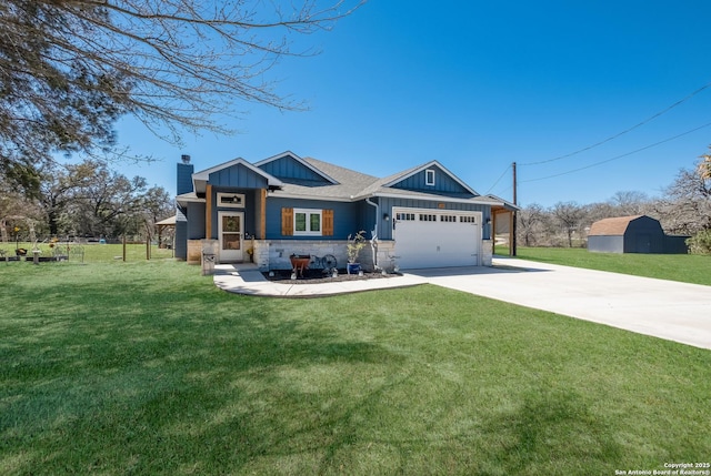 view of front of property with driveway, board and batten siding, a front yard, an attached garage, and a chimney