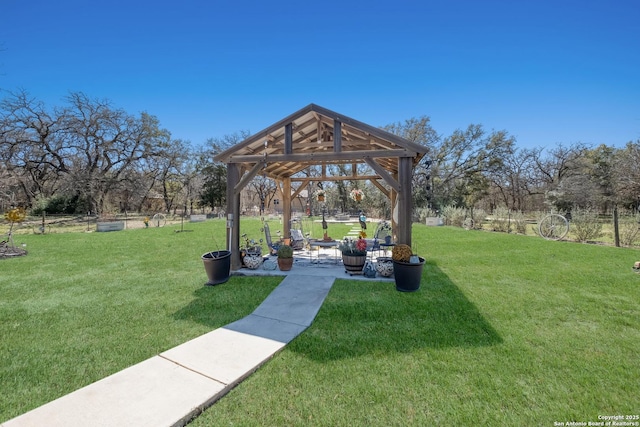 view of property's community with a gazebo and a yard