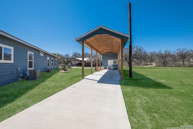 view of property's community with concrete driveway and a yard