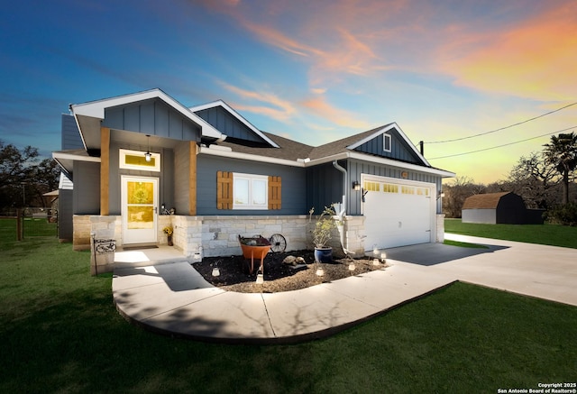 view of front facade with a garage, stone siding, board and batten siding, and concrete driveway