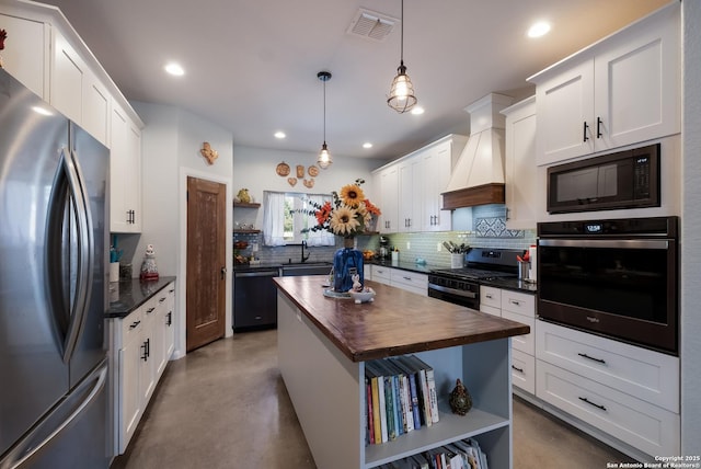 kitchen with wooden counters, concrete floors, custom exhaust hood, black appliances, and open shelves