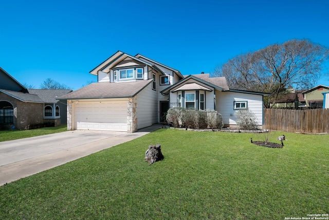 view of front of house featuring an attached garage, concrete driveway, a front yard, and fence