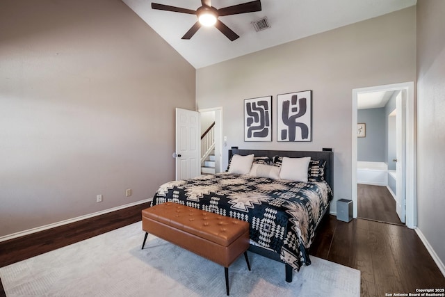 bedroom featuring visible vents, baseboards, high vaulted ceiling, and wood finished floors