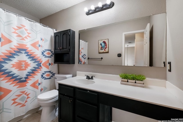 bathroom featuring tile patterned flooring, toilet, a textured ceiling, and vanity