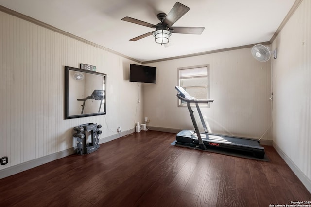 workout room featuring a ceiling fan, crown molding, baseboards, and wood finished floors