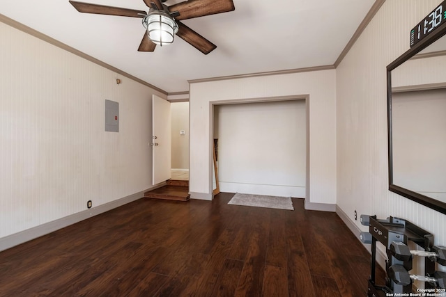 unfurnished bedroom featuring a ceiling fan, wood finished floors, baseboards, electric panel, and crown molding