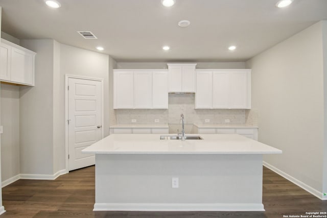 11583 Cottage Pt, San Antonio, TX 78254 - kitchen featuring white cabinets, a center island with sink, visible vents, decorative backsplash, and a sink