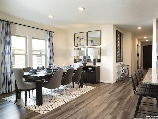 dining room with recessed lighting, a textured ceiling, baseboards, and wood finished floors