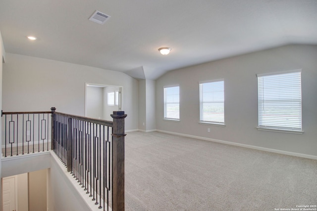 11583 Cottage Pt, San Antonio, TX 78254 - empty room with light carpet, visible vents, baseboards, and vaulted ceiling